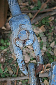 RUSTED CHAIN ATTACHMENT ON OLD TRACTOR