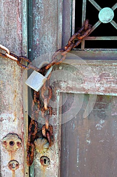 Rusted Chain on Old Bronze Door