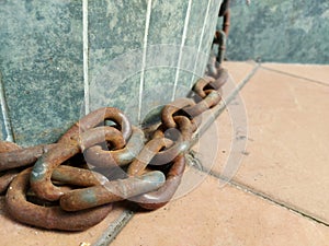 Rusted chain unused in the daylight