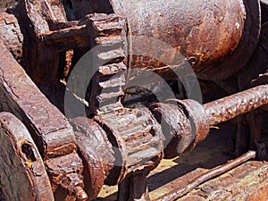 Rusted cogs and gears on an old broken industrial machine