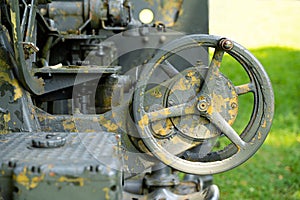 Rusted guidance wheel on decommissioned artillery cannon