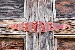 Rusted hinge on an old wooden door