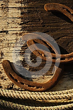 Rusted horseshoes on wooden texture background
