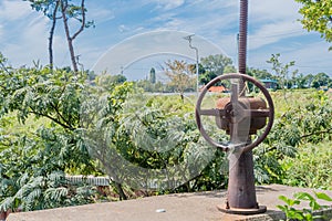 Rusted irrigation gate valve in rural countryside