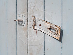 Rusted keyhole on old wooden door