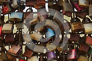 Rusted love locks on a fence