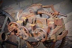 Rusted machinery detail in red tone. Grunge background.