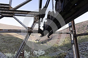 Rusted metal iron wheel from industrial coal mining industry in abandoned building