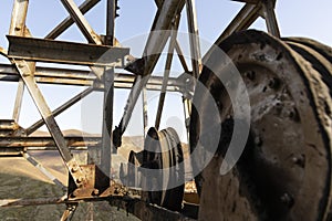 Rusted metal iron wheel from industrial coal mining industry in abandoned building