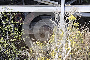 Rusted metal iron wheel from industrial coal mining industry in abandoned building