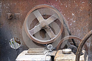 Rusted metal pulley wheels with gas tanks