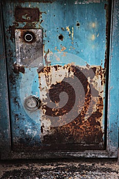 Rusted metal sheet door in blue