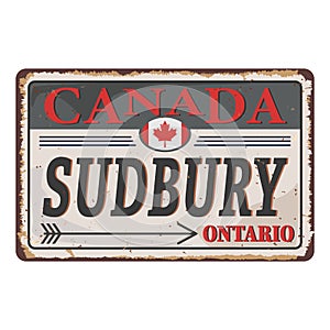Rusted metal sign Sudbury, Ontario, Canada that features maple leaves. photo