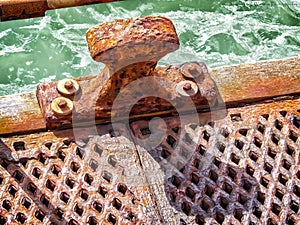 Rusted metal surface on old pier by ocean