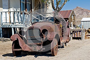 Rusted old car in desert