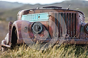 Rusted old car in field in Hawaii