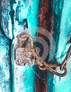 Rusted old iron lock on wooden gate