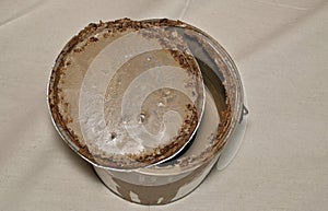 Rusted old metal paint tin with open lid concept.