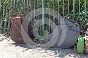 A rusted old metal tractor arm