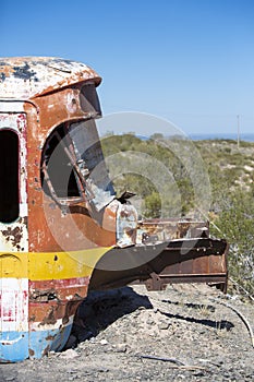 Rusted out old school bus abandoned in the countryside