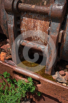 Rusted Piece of Mining Equipment and Weeds