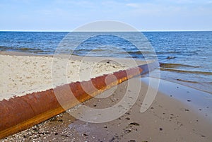 Rusted pipe in blue sea