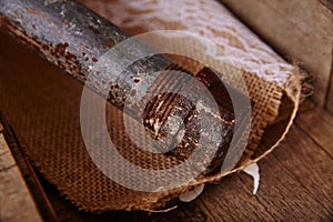 Rusted Pipe and Bolt on Burlap Texture - Close-Up View