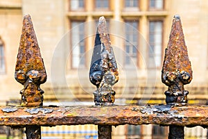 Rusted railing with spikes