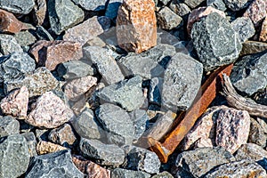 Rusted Railroad Spike in Loose Rock