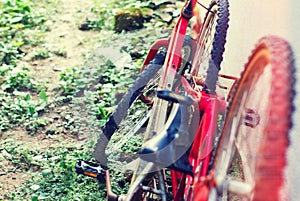 Rusted red vintage bicycle at wall