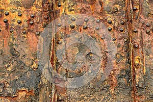 Rusted riveted steel hull. Abstract, background.