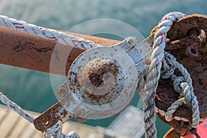 Rusted by saltwater pulley and old rope on a working lobster boa