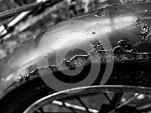 Rusted steel mudguard ona vintage British bicycle - in black and white