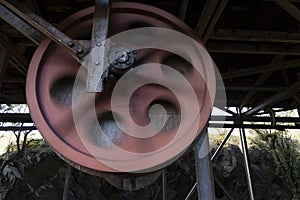 Rusted steel roller wheel abandoned industrial equipment from coal mining