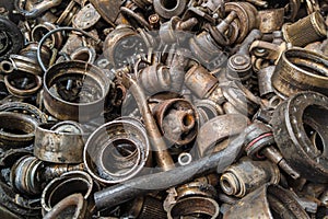 rusted steel scrap pile of used car parts and pieces