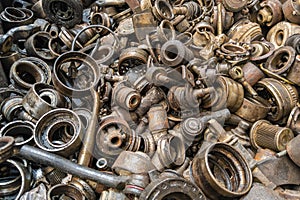 rusted steel scrap pile of used car parts and pieces