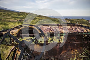 Rusted vintage car in field, Hawaii