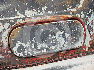 Rusted and weathered air intake flap of a rotten old truck