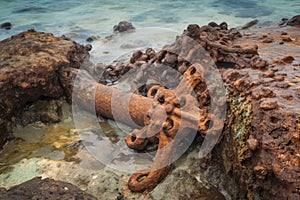 rusted and weathered anchor from long-lost shipwreck being dragged up from the depths