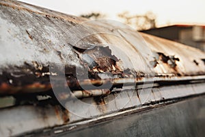 Rusted white painted metal wall. Rusty metal background with streaks of rust. Rust stains. The metal surface rusted spots.metal