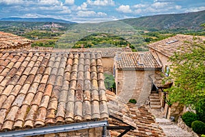 The rustic architecture of the perched village of Lacoste, France, overlooking a large valley in Provence.