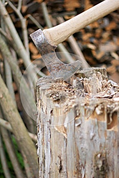 Rustic axe stuck in wooden stump