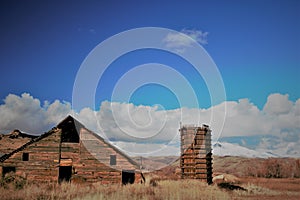 Rustic barn and water tower, snow capped mountain back ground