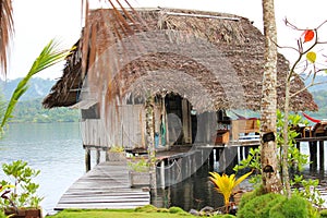 Rustic beach cabin on stilts over water on the beach