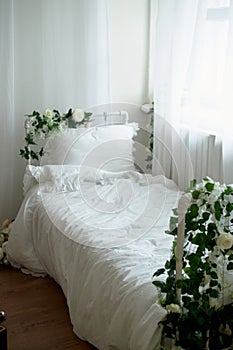 Rustic bed with flowers, white cotton linen. Metal Frame