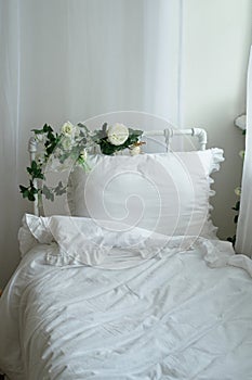 Rustic bed with flowers, white cotton linen. Metal Frame