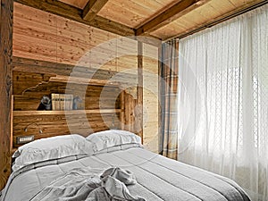 Rustic bedroom interior with wooden wainscoting