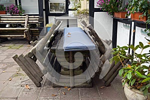 Rustic benches and tables pushed together in a closed terrace restaurant, lockdown due to coronavirus pandemic with substantial