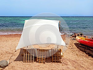 Rustic Berber chill out on the Red Sea coast in the Sinai Peninsula. Rustic canvas on the beach of Dahab. Awning and tent in the