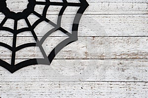 Rustic black spiderweb Halloween background concept on wood backdrop